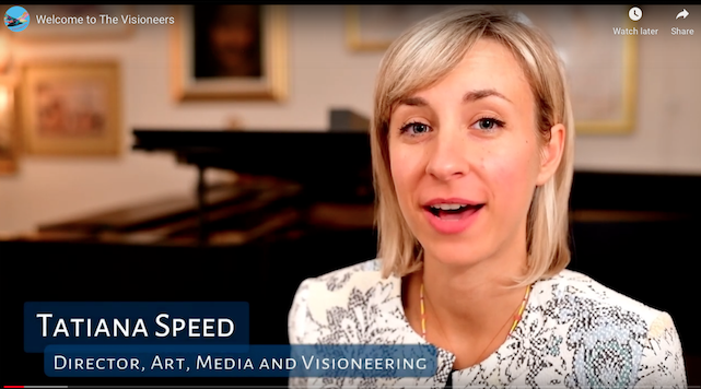 Tatiana Speed, Artistic Director for the Visioneers, talking in front of a bookshelf